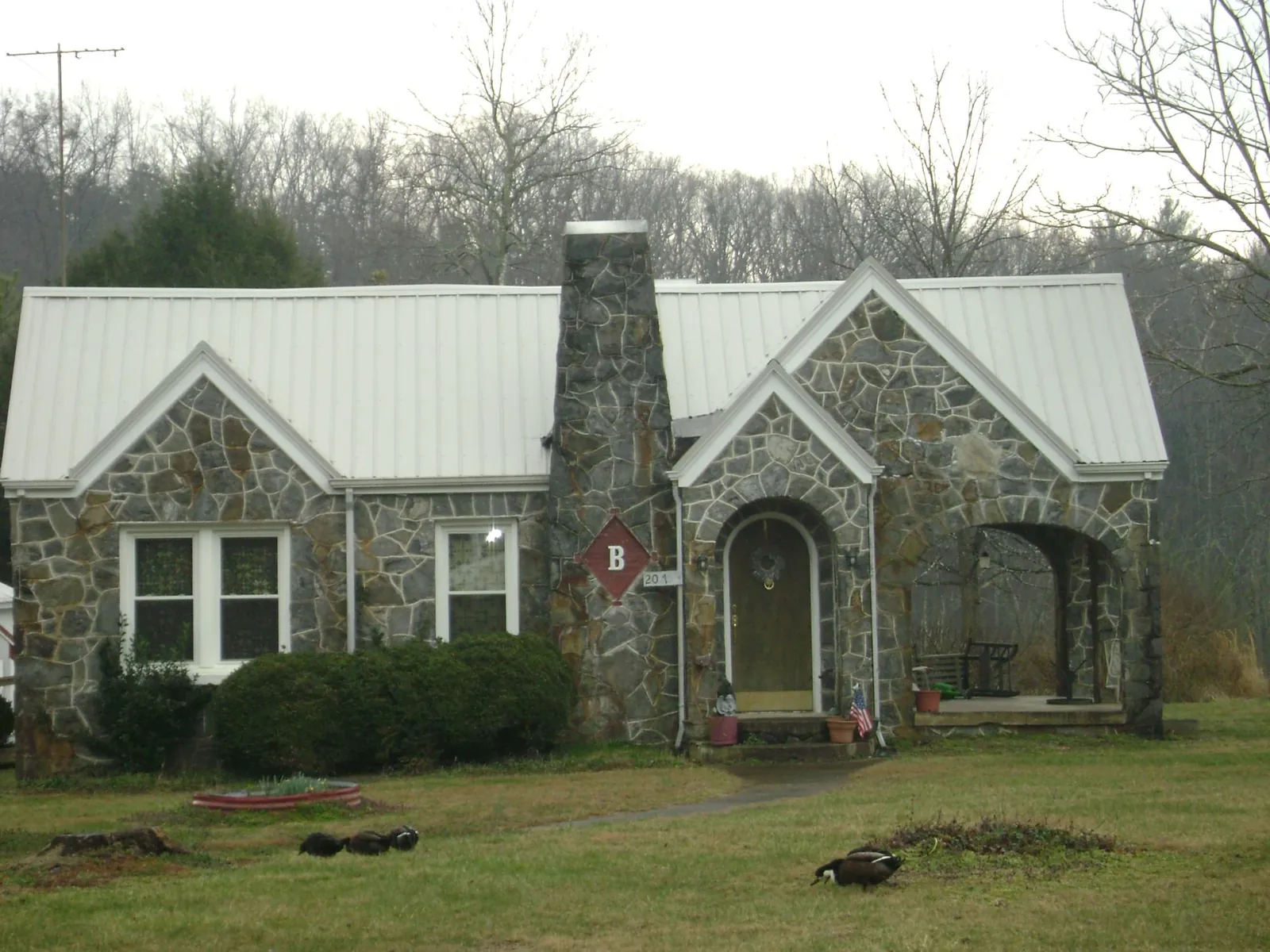 White metal roof on a stone cottage with steep gables in Hyde Park